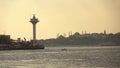 Seascape with wiews of old historical buildings of Istanbul Turkey with ancient mosques and sea lighthouse at sunset