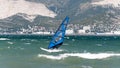 Seascape with windsurfing. a windsurfer rides on the waves catching the wind with a sail. the sea, mountains, waves. Royalty Free Stock Photo