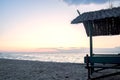 Seascape, wooden gazebo on the coast in the evening