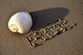 Seashell on the beach and the inscription on the sand is free.