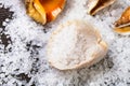 Seashell with coarse grained Sea Salt on table