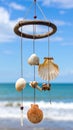 Seashell Mobile Ornament with Varied Seashells Suspended Against a Serene Beach Backdrop Royalty Free Stock Photo