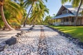 a seashell pathway leading to a beachfront tropical cottage