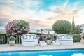 Seashell shaped chairs around a swimming pool Royalty Free Stock Photo