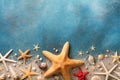 Seashell, starfish and beach sand on blue background. Summer holiday concept. Top view and flat lay Royalty Free Stock Photo