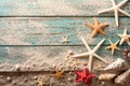 Seashell, starfish and beach sand on blue wooden background. Summer holiday concept. Top view Royalty Free Stock Photo