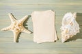 Seashell, starfish and old parchment on a wooden background. The concept of a summer vacation at sea. Copy space. Royalty Free Stock Photo