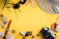 Seashells, accessories and camera on yellow background. Seaside adventures Royalty Free Stock Photo