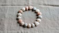 Seashells arranged in a circular pattern on a textured beige fabric Royalty Free Stock Photo