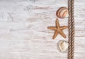 Seashells and rope on the old wood. Marine background Royalty Free Stock Photo