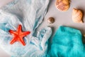 Seashells and starfish on cian and white cloth