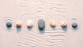 Seashells and stones arranged on light sand with flowing wave patterns for zen vibes Royalty Free Stock Photo