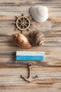 Seashells, wooden anchor and blue chalk