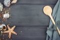 Seashells,wooden spoon and dish towel on the blue wooden