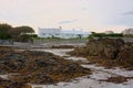 Seashore beach property with seaweed covered rocks.