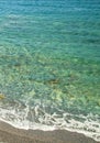 Seashore with calm surf, bright clear emerald water. Background for a mobile phone Royalty Free Stock Photo