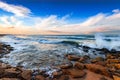 Seashore with cliffs, waves crashing on rocks