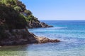 Seashore coastline with cliff and rocks on a mountain slope. Blue sea of the Island of Elba in Italy in the Tuscany region.