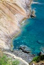 Seashore coastline with cliff and rocks on a mountain slope. Blue sea of the Island of Elba in Italy in the Tuscany region.