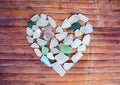 Seashore Glass Pebble Heart On Wooden Background. Sugar Glass Mosaic For Valentine`s Day.