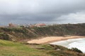 Seashore with high cliffs and big waves on a cloudy day Royalty Free Stock Photo