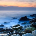 Seashore with misty water at sunset