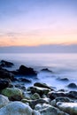 Seashore with misty water at sunset