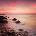 Seashore with misty water at sunset