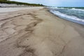 Seashore after rain, wet sea sand, deserted sea beach Royalty Free Stock Photo