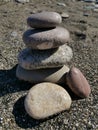 The seashore. Sandy beach. The tower is made of sea pebbles. Balance. Royalty Free Stock Photo