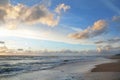 Seashore sky orange and blue tones clouds and sea waves sand beach with beautiful nature bright sunset Royalty Free Stock Photo