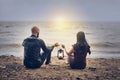 On the seashore a young couple guy and girl at sunset. man and woman hold flashlight in hands together Royalty Free Stock Photo