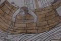 Seasick sailor haning out over the gunwale, an old fresco from the 1500s