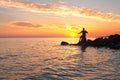 Seaside with a beautiful sunset and a young fishing men