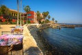 Seaside dining setup with colorful tablecloths on Goree Island, Senegal