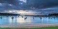 Seaside harbour panorama seascape with boats and rain clouds