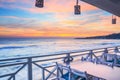 Seaside landscape - the cafe on the embankment with views of the sunrise over the sea Royalty Free Stock Photo