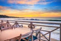 Seaside landscape - the cafe on the embankment with views of the sunrise over the sea Royalty Free Stock Photo