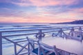 Seaside landscape - the cafe on the embankment with views of the sunrise over the sea Royalty Free Stock Photo