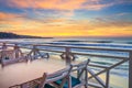 Seaside landscape - the cafe on the embankment with views of the sunrise over the sea Royalty Free Stock Photo