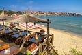 Seaside landscape - view of the cafe and the sandy beach with umbrellas and sun loungers in the town of Sozopol Royalty Free Stock Photo