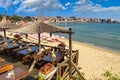 Seaside landscape - view of the cafe and the sandy beach with umbrellas and sun loungers in the town of Sozopol Royalty Free Stock Photo