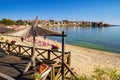 Seaside landscape - view of the cafe and the sandy beach with umbrellas and sun loungers in the town of Sozopol Royalty Free Stock Photo