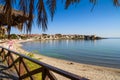 Seaside landscape - view from the cafe to the sandy beach with umbrellas and sun loungers in the town of Sozopol Royalty Free Stock Photo