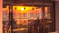 Seaside landscape - view of the coastal cafe with the reflection in glass of sunrise over the sea Royalty Free Stock Photo