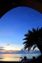 Seaside palm trees with swimming pools and wooden walkways, at dawn the sky is blue and cloudy Royalty Free Stock Photo