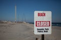 Seaside Park, NJ - Nov 10, 2013 - Beach closed sign with Funtown pier in the distance devistated from Hurricane Sandy and a later Royalty Free Stock Photo