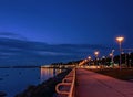 Seaside promenade at night ligt bluurring water reflection neon Street lamp panorama Tallinn Baltic sea Nigh modern cit