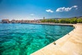 Seaside promenade in Supetar town on Brac island with palm trees and turquoise clear ocean water, Supetar, Brac, Croatia, Europe Royalty Free Stock Photo