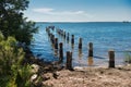 Remains of the pier and pillars in the ocean water Royalty Free Stock Photo